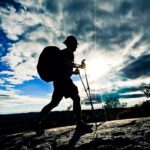 A thru-hiker traverses Cat Rocks as the sun sets.