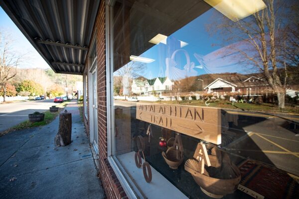 Wooden Appalachain Trail sign in the window of a downtown Damascus storefront