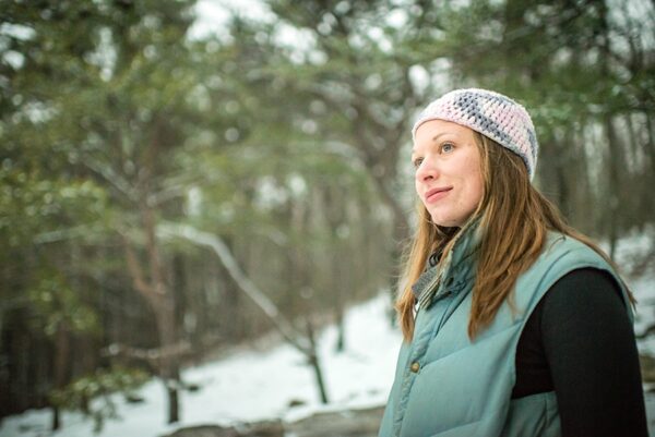 Nicole Wooten looks out on snowy landscape thoughtfully
