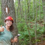 Young Volunteer Paints a White Blaze marking the Appalachian Trail.