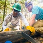 Rocky Top Trail Crew Members saw a wooden support beam for an Appalachian Trail rehab project. Photo by Horizonline Pictures