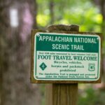 The Appalachian National Scenic Trail sign with a white blaze in the background. Photo by Horizonline Pictures