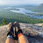 Hiker's boots photographed over a valley