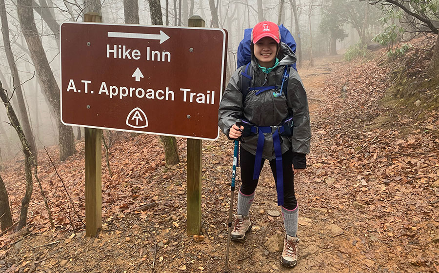 Hiker poses by the A.T. Approach Trail sign
