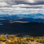 White Cap Mountain with clouds overhead and golden vegetation below.