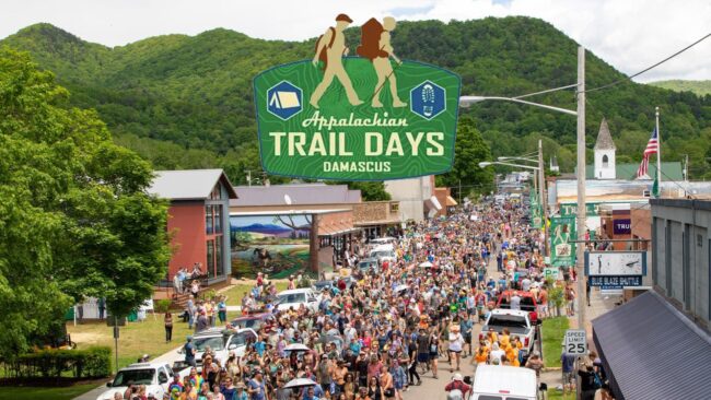 The Hiker Parade at Appalachian Trail Days 2022, with Trail Days Logo