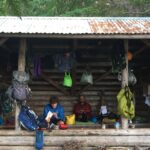 Hiker reading at a shelter