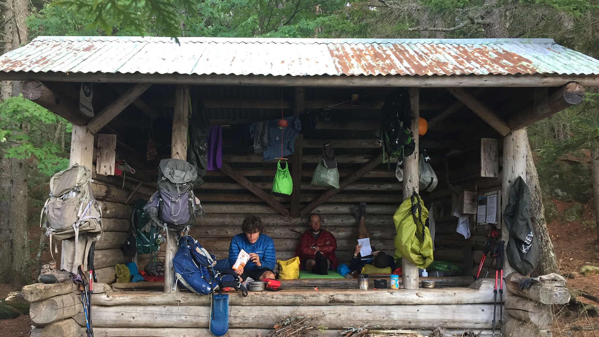 Hiker reading at a shelter