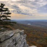 Scenic view of landscape with rocky outcropping in foreground