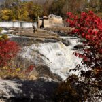 Waterfall surrounded by bright red fall foliage