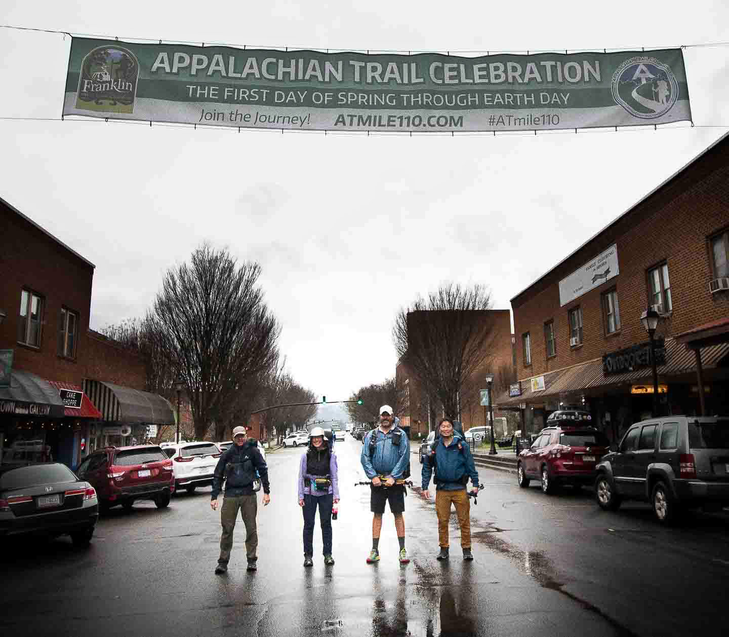 Hikers under a banner in Franklin, NC