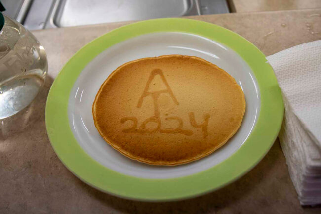 A pancake with the AT logo and