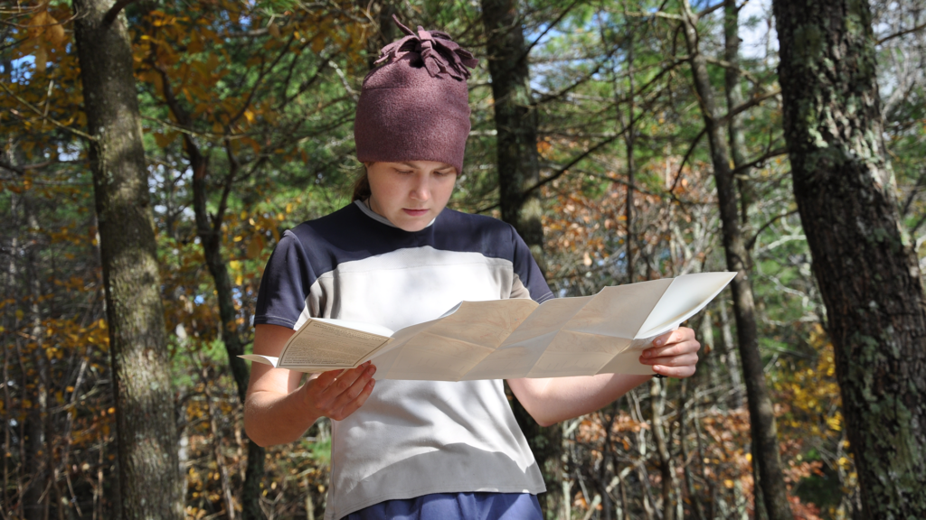 A hiker reads a paper map