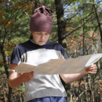 A hiker reads a paper map