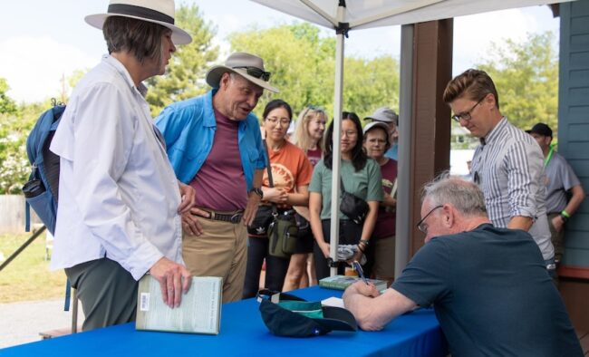 Group gathering around ATC table at event