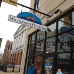 Walkabout Outfitter sign hanging outside a glass shopfront.