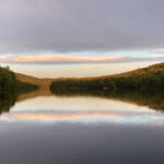 Upper Goose Pond reflecting a hazy sunset