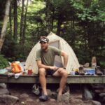 A.T. hiker poses in front of campsite