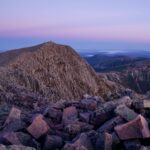 Rocky ridgeline on Knifes Edge Trail against a purple and blue sky