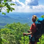 Female hiker overlooks mountain vista from the Appalachian Trail.