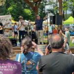 Live band plays on an outdoor stage to an audience