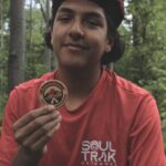 Soul Trak participant holds up a Jr Ridgerunner badge.