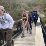 Katie Frawley (left) walks across a small bridge with other ELS participants.