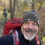 Jeff Hunter hikes along the Appalachian Trail wearing a pack and beanie.