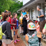 ATC volunteer presents to a group of visitors outside Harpers Ferry HQ building