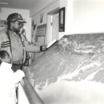 Man and young girl look at relief map exhibition of Appalachian Trail, photo taken in black and white.