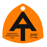 Bright orange A.T. hangtag with black A.T. symbol.