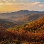Rolling mountains and valleys blanketed in colorful fall foliage