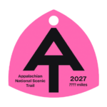 Hot pink A.T. hangtag with black A.T. symbol.